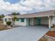 Charming single-story home featuring a long driveway and carport at 1509 Cherry Hills Dr, Sun City Center, FL 33573