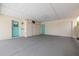 Spacious garage with painted floor, interior storage, and two access doors at 1509 Cherry Hills Dr, Sun City Center, FL 33573