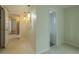 Hallway features modern hanging lighting and access to other rooms at 1509 Cherry Hills Dr, Sun City Center, FL 33573