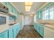 Classic kitchen features light blue cabinets and appliances, including a double oven at 1509 Cherry Hills Dr, Sun City Center, FL 33573