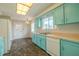 Charming kitchen featuring vintage blue cabinetry and ample countertop space at 1509 Cherry Hills Dr, Sun City Center, FL 33573