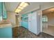 Vintage kitchen with blue cabinets, tile backsplash, and bright overhead lighting at 1509 Cherry Hills Dr, Sun City Center, FL 33573