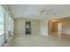 Bright living room with large windows, ceiling fan, and neutral paint at 1509 Cherry Hills Dr, Sun City Center, FL 33573