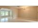 Spacious living room featuring neutral walls and a ceiling fan at 1509 Cherry Hills Dr, Sun City Center, FL 33573