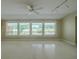 Bright living room with large windows and view of a green field at 1509 Cherry Hills Dr, Sun City Center, FL 33573