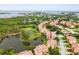 Picturesque aerial view of a residential community surrounding a tranquil lake, showcasing lush landscaping at 1532 Citrine Trl, Tarpon Springs, FL 34689