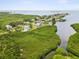 Stunning aerial view of waterfront homes surrounded by lush mangroves and serene bay waters at 1532 Citrine Trl, Tarpon Springs, FL 34689