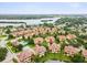 Expansive aerial shot of Sunset Bay townhome community featuring waterfront views, a pool, and well-maintained grounds at 1532 Citrine Trl, Tarpon Springs, FL 34689