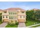 A bird's-eye view of a beautiful multi-story townhome with a red tile roof and a well-kept landscape at 1532 Citrine Trl, Tarpon Springs, FL 34689
