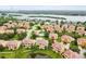 Beautiful aerial view of the Sunset Bay community with lush landscaping, serene pond, and inviting swimming pool at 1532 Citrine Trl, Tarpon Springs, FL 34689