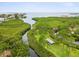 Scenic aerial view of a waterway, covered picnic area and canopy of trees lining a peaceful waterfront at 1532 Citrine Trl, Tarpon Springs, FL 34689