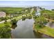 Beautiful aerial view of the area with a pond surrounded by lush greenery at 1532 Citrine Trl, Tarpon Springs, FL 34689