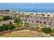 Beautiful aerial shot of a beach featuring clear turquoise water, palm trees, and a parking area at 1532 Citrine Trl, Tarpon Springs, FL 34689