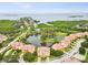Stunning aerial view highlighting the location of this lovely residence nestled beside a serene lake at 1532 Citrine Trl, Tarpon Springs, FL 34689