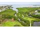 Picturesque aerial view showcasing a tranquil waterway, green space, and waterfront community at 1532 Citrine Trl, Tarpon Springs, FL 34689