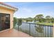 Scenic balcony with iron railings and a view of the pond and natural greenery at 1532 Citrine Trl, Tarpon Springs, FL 34689