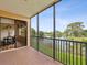 Relax on the screened balcony with views of the tranquil lake at 1532 Citrine Trl, Tarpon Springs, FL 34689