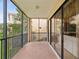 Outdoor balcony features ample seating and views of the surrounding trees and buildings at 1532 Citrine Trl, Tarpon Springs, FL 34689