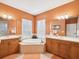The primary bathroom features dual vanities and a relaxing tub at 1532 Citrine Trl, Tarpon Springs, FL 34689