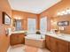 The luxurious bathroom features dual vanities and a separate tub at 1532 Citrine Trl, Tarpon Springs, FL 34689