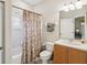 Bright bathroom with shower, tub, and charming vanity at 1532 Citrine Trl, Tarpon Springs, FL 34689