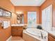 Bathroom with a soaking tub and ample natural light at 1532 Citrine Trl, Tarpon Springs, FL 34689