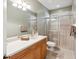 Bathroom features tiled walls, a glass shower, and wood toned cabinets at 1532 Citrine Trl, Tarpon Springs, FL 34689