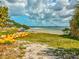 Picturesque beach view featuring sandy shoreline, colorful paddle boats, and clear blue water at 1532 Citrine Trl, Tarpon Springs, FL 34689
