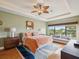 Relaxing primary bedroom features a spacious layout, tray ceiling, and peaceful views of the water at 1532 Citrine Trl, Tarpon Springs, FL 34689