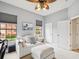 Comfortable bedroom featuring a ceiling fan, a stylish sofa, and a tranquil ambiance at 1532 Citrine Trl, Tarpon Springs, FL 34689