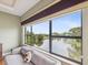 Relaxing primary bedroom sitting area offers gorgeous views of the community pond at 1532 Citrine Trl, Tarpon Springs, FL 34689