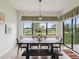 Dining area includes a dark wood table and chairs overlooking a serene lake and golf course at 1532 Citrine Trl, Tarpon Springs, FL 34689