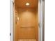 Interior view of the residential elevator with paneled walls, carpet flooring, and telephone at 1532 Citrine Trl, Tarpon Springs, FL 34689