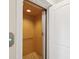 Residential elevator with wood paneled walls and carpet flooring, located near a doorway at 1532 Citrine Trl, Tarpon Springs, FL 34689
