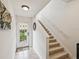 Inviting entryway with tiled floors, staircase, and a glass pane front door allowing natural light at 1532 Citrine Trl, Tarpon Springs, FL 34689