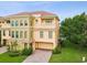 Elegant townhome featuring a paver driveway, attached garage, and beautiful landscaping at 1532 Citrine Trl, Tarpon Springs, FL 34689