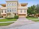 Attractive multi-story townhome with a well-manicured lawn and a brick-paved driveway at 1532 Citrine Trl, Tarpon Springs, FL 34689