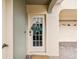 Inviting front door with glass panel and decorative wreath; creating a warm welcome at 1532 Citrine Trl, Tarpon Springs, FL 34689