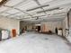 Spacious garage featuring block walls, concrete flooring, and ample space for parking and storage at 1532 Citrine Trl, Tarpon Springs, FL 34689
