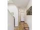 Bright hallway features tile flooring and unique wall art, leading to various rooms at 1532 Citrine Trl, Tarpon Springs, FL 34689