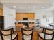 Kitchen island boasts granite countertops with bar stool seating and light wood cabinets at 1532 Citrine Trl, Tarpon Springs, FL 34689