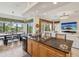Kitchen overlooks the dining area with a breakfast bar, stainless appliances, and views of living area at 1532 Citrine Trl, Tarpon Springs, FL 34689