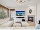 Cozy living room with a fireplace, large TV, and comfortable seating arrangement at 1532 Citrine Trl, Tarpon Springs, FL 34689
