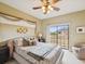 Comfortable main bedroom with balcony access and natural light at 1532 Citrine Trl, Tarpon Springs, FL 34689