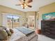 Cozy main bedroom featuring a TV, bathroom, and balcony access at 1532 Citrine Trl, Tarpon Springs, FL 34689
