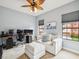 Office with multiple monitors, a comfortable couch, and a ceiling fan at 1532 Citrine Trl, Tarpon Springs, FL 34689