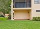 Ground level patio with green views, accessible from the door on the beige exterior at 1532 Citrine Trl, Tarpon Springs, FL 34689