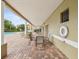 Covered outdoor patio area with tables and chairs, and a view of the pool at 1532 Citrine Trl, Tarpon Springs, FL 34689