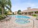 Community pool and hot tub with lounge chairs offers a relaxing outdoor space for residents at 1532 Citrine Trl, Tarpon Springs, FL 34689