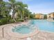 View of the community pool and hot tub that offers a relaxing outdoor space for residents at 1532 Citrine Trl, Tarpon Springs, FL 34689